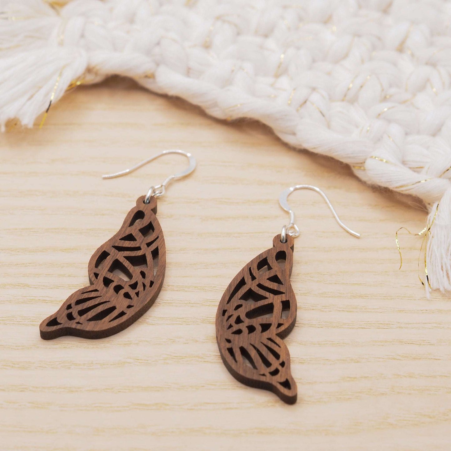 Butterfly wing drop earrings in walnut wood suspended on delicate sterling silver hooks