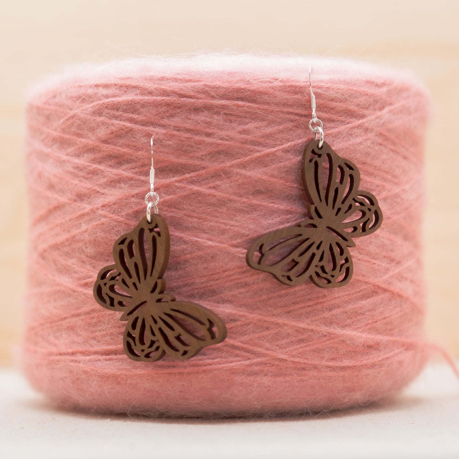 Delicate and cute our butterfly drop earrings hang on recycled sterling silver hooks