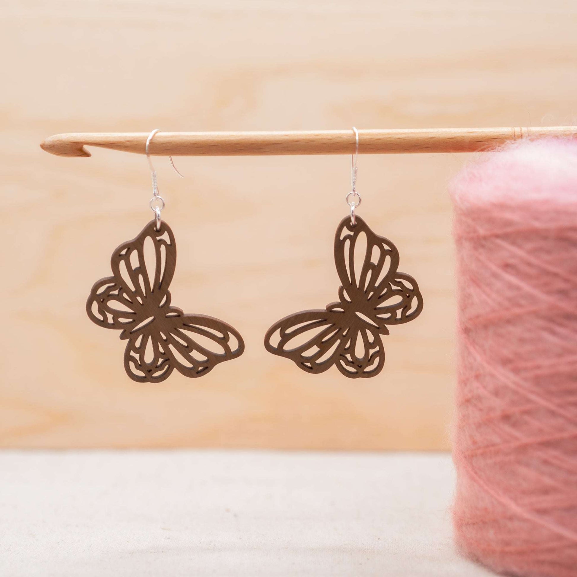 Butterfly drop earrings hung on delicate sterling silver hooks