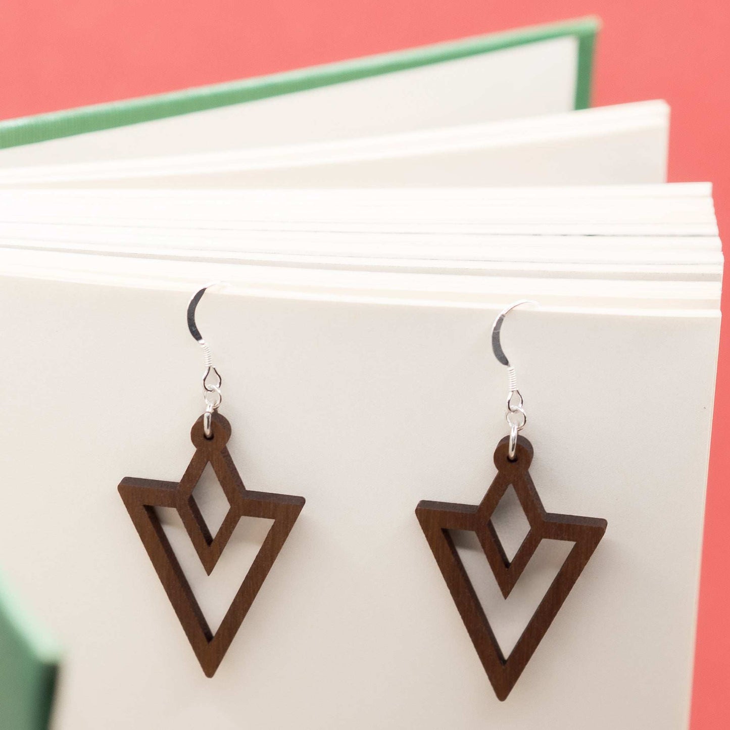 Triangle outline drop earrings hung on delicate sterling silver hooks