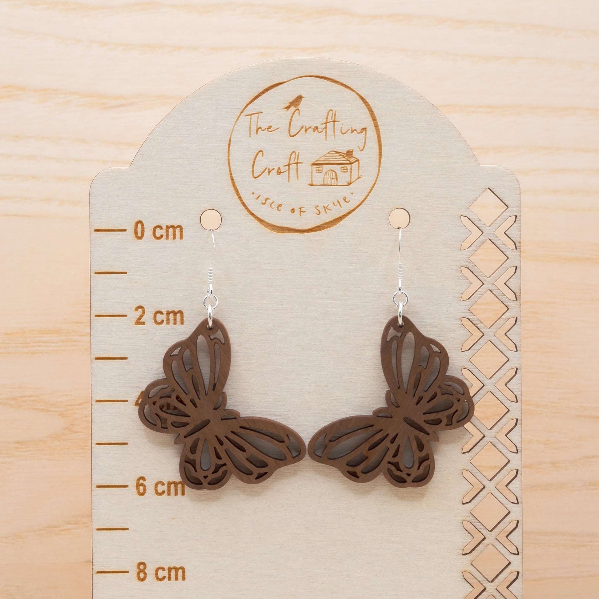 Butterfly drop earrings laser cut in solid walnut and hand finished on The Isle of Sky